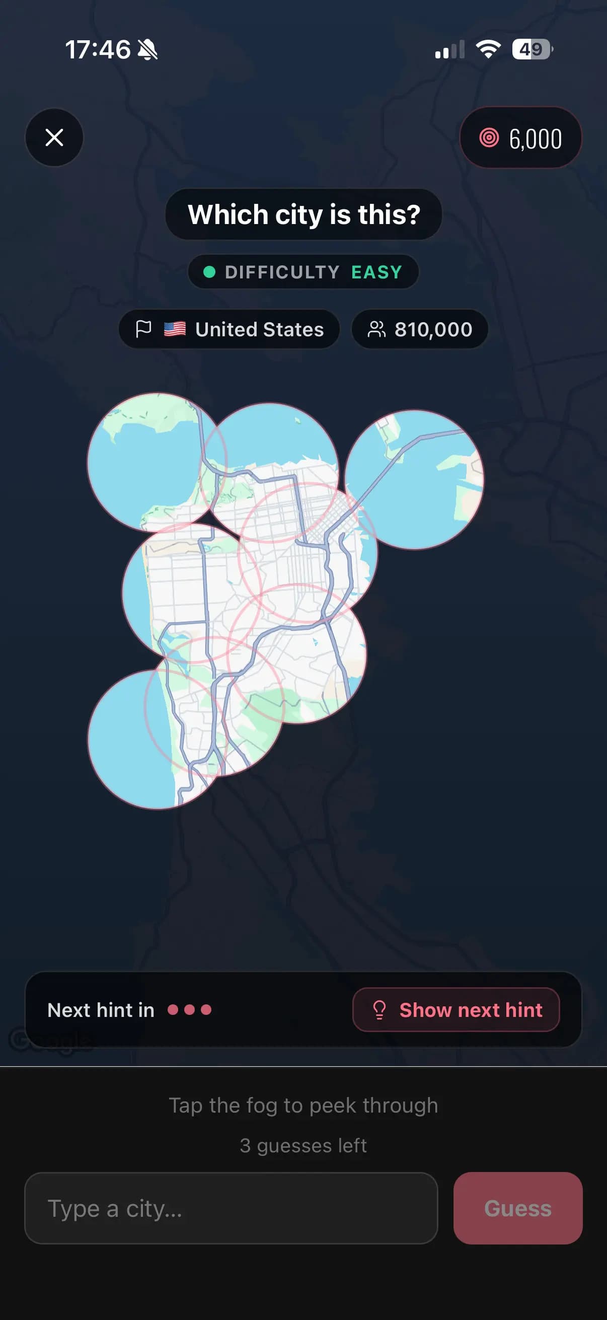 Fog Guesser mid-round: peepholes tapped into the fog reveal map fragments, with country and population hints unlocked